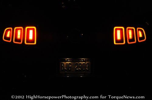 The 2013 Ford Mustang GT Premium Coupe from the rear in the dark