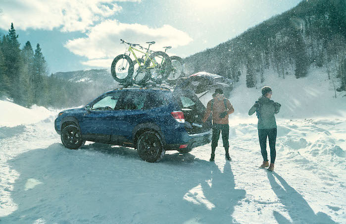 2024 Subaru Forester with customers in the snow