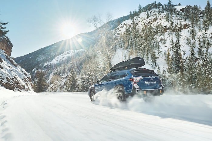 2024 Subaru Outback driving in fresh snowy powder