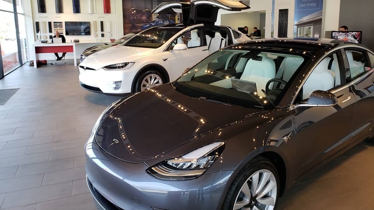 Image of Tesla Model 3 and Model Y inside showroom by John Goreham. 