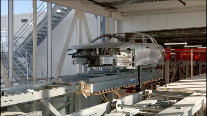 Image showing an unpainted and partially assembled Lucid Air moving through the AMP-1 production facility.
