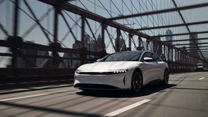 Image of a white Lucid Air driving over the Brooklyn bridge.