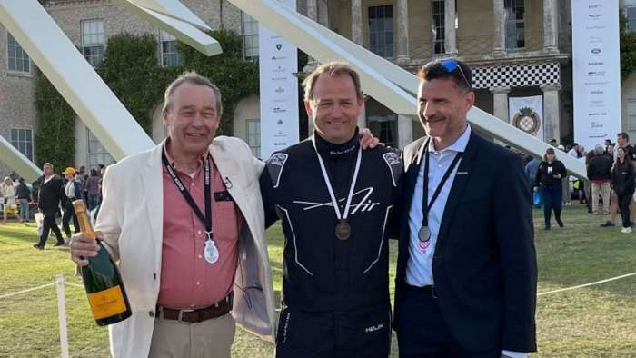 Photo of Lucid CEO Peter Rawlinson with driver Ben Collins celebrating the Air Grand Touring Performance's victory at Goodwood.