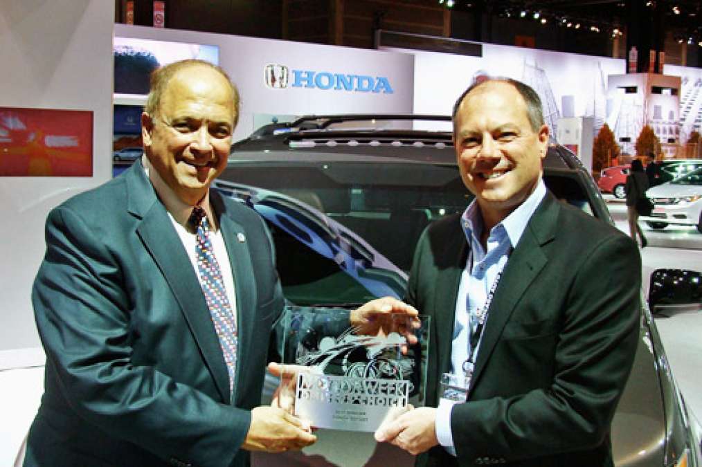 MotorWeek's John Davis (left) presents American Honda's VP of marketing operatio