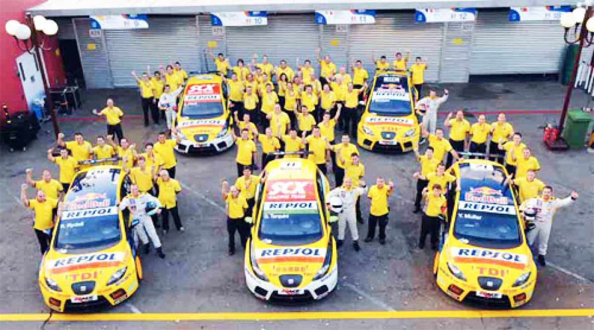SEAT workers surround racing Leon Supercopas. Photo courtesy of SEAT