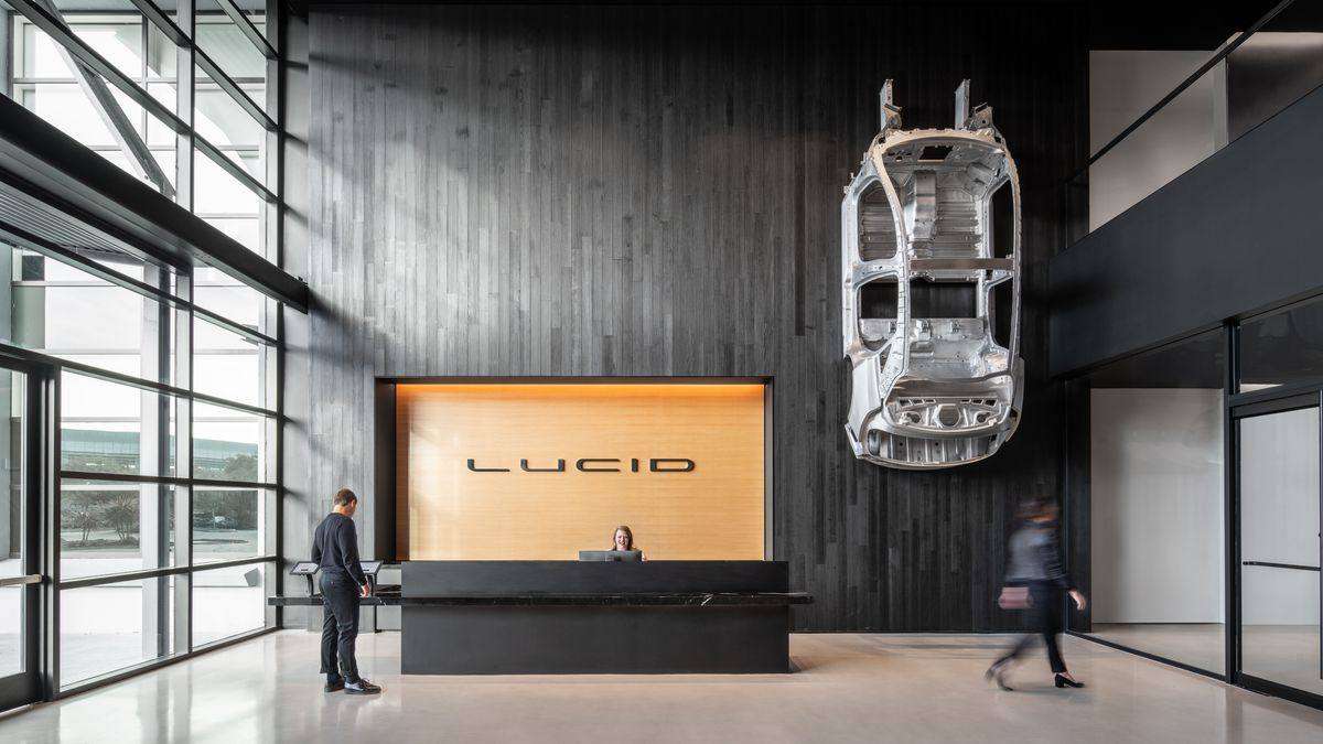 Image of the interior of Lucid's California headquarters with an example of the Lucid Air's unibody chassis hanging from the wall.