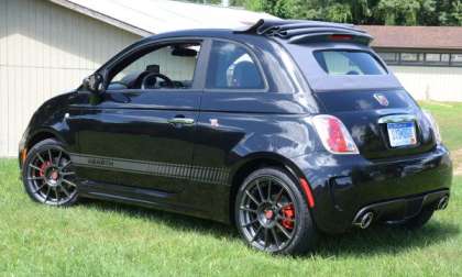 The side profile of the 2013 Fiat 500C Abarth with the top partially up