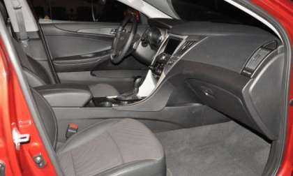 The front seating area of the 2012 Hyundai Sonata SE, shown in black.