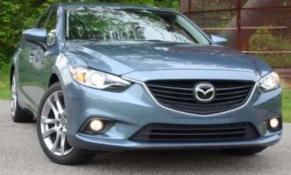 The front end of the 2014 Mazda6 Grand Touring with the headlights on