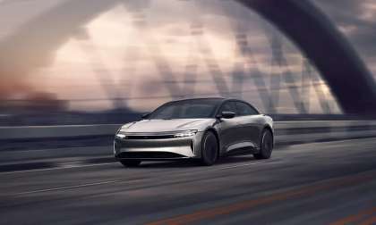 Image showing a Lucid Air with Stealth Appearance Package driving on a bridge.