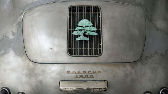 Close-up view of the bronze bonsai tree emblem on the Porsche 356 Bonsai's rear grille.