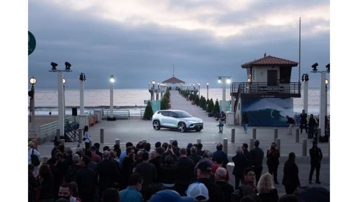 Image showing a white Fisker Ocean parked on Manhattan Beach Pier with a crowd gathered to see it.
