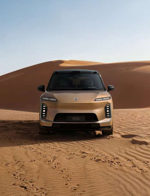 The front view of a gold NIO ES9 SUV