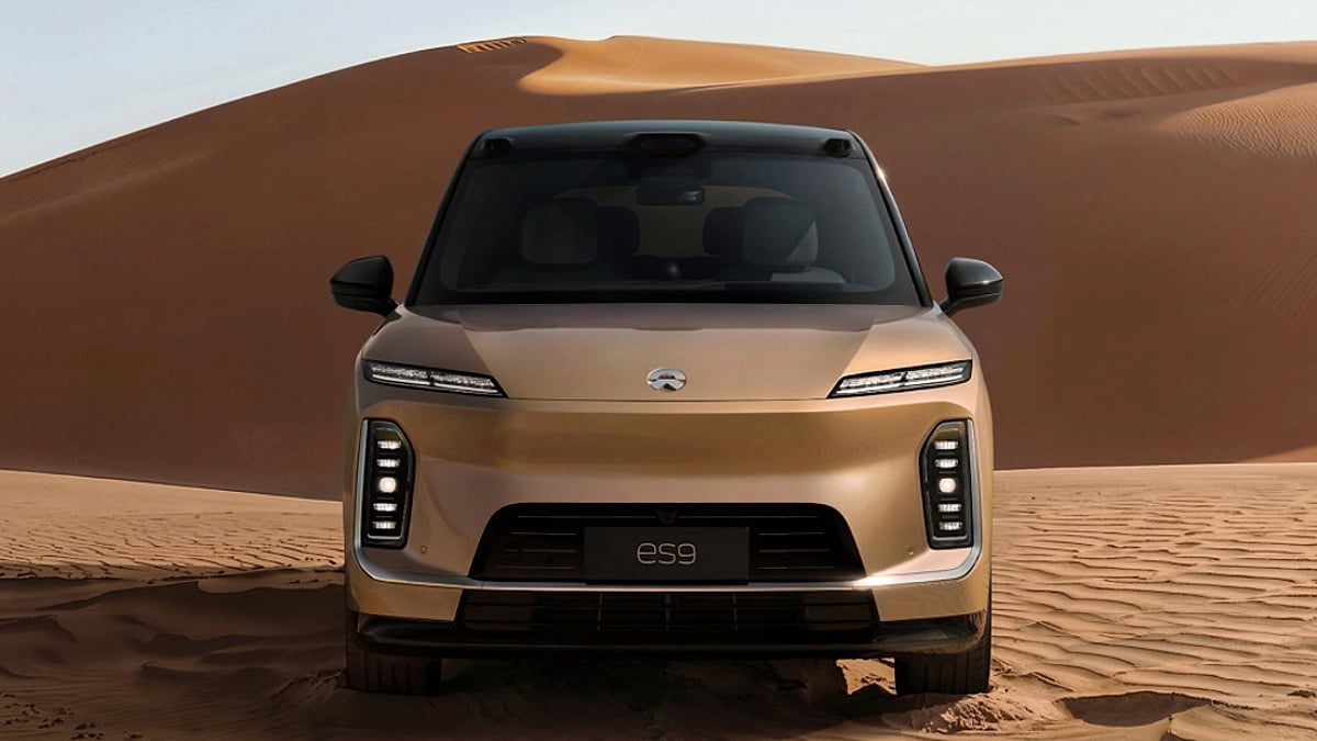 Golden NIO ES9 SUV facing front, desert.
