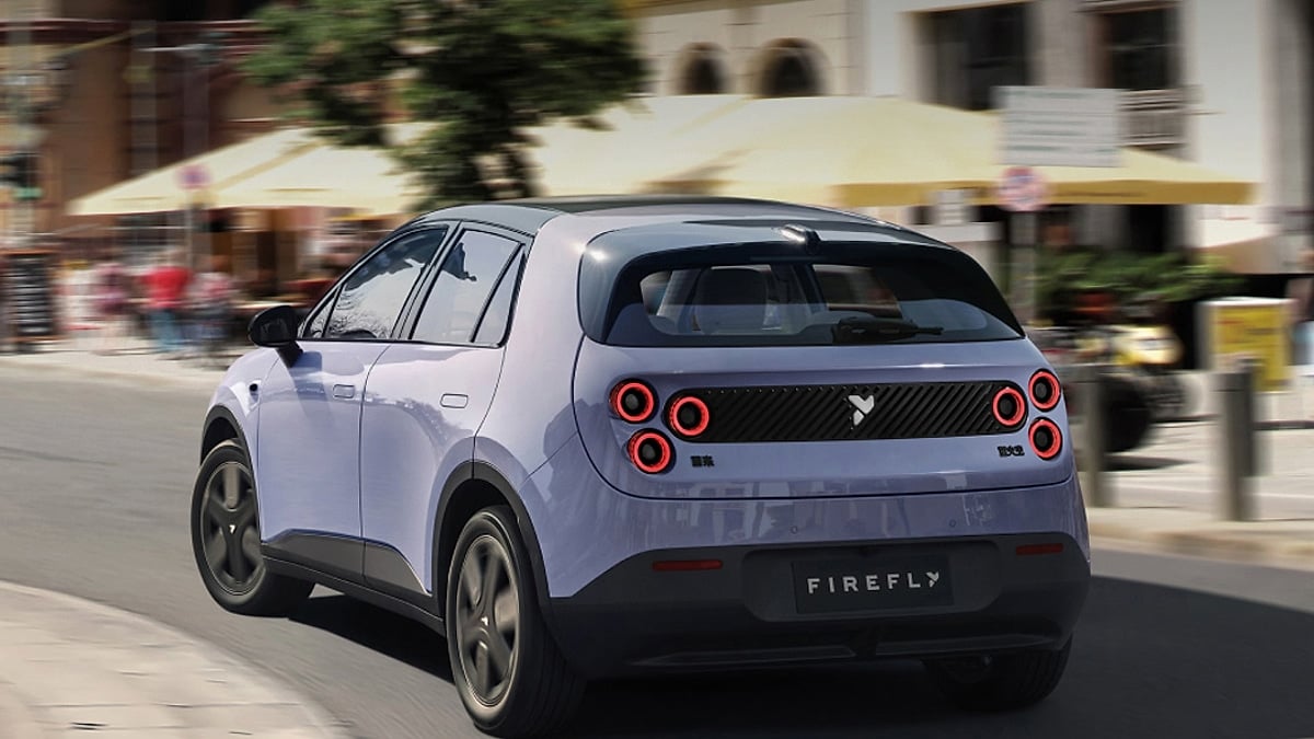 Light blue Firefly car driving down the street