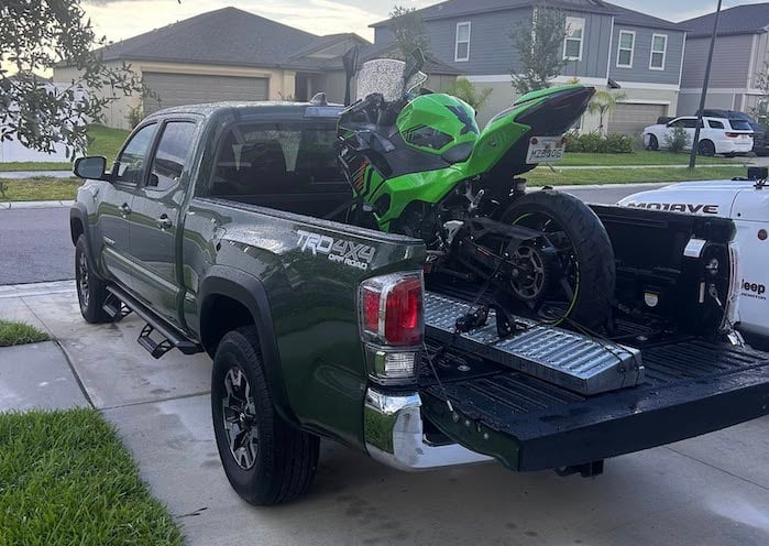 Connor's 2021 Toyota Tacoma TRD Off-Road with a motorcycle in the bed