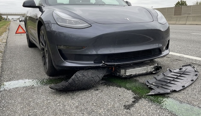 2023 Tesla Model with damage from a semi tire blowout