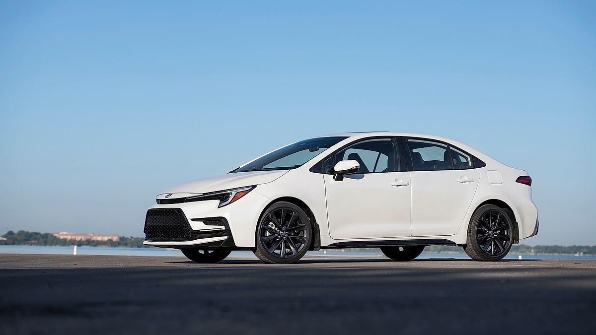 White 2023 Toyota Corolla XSE parked near the water in a clean side-profile view.