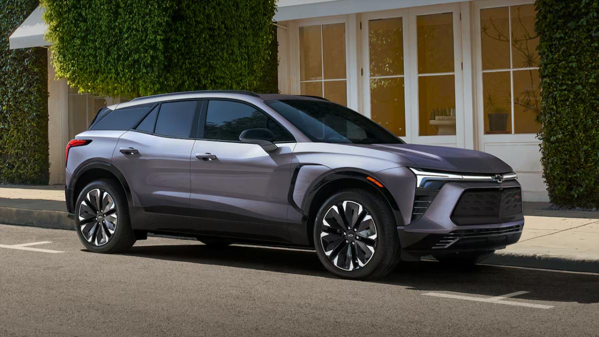2024 Chevrolet Blazer EV in silver-gray, electric SUV parked on street with ivy-covered wall