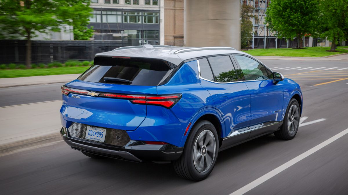 Bright blue Chevrolet Blazer EV SUV driving on city street with motion blur effect