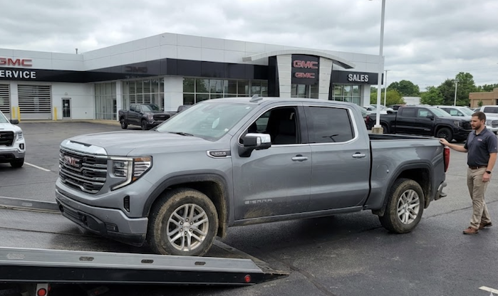 Bo Darville's 2024 GMC Sierra being unloaded off a tow truck