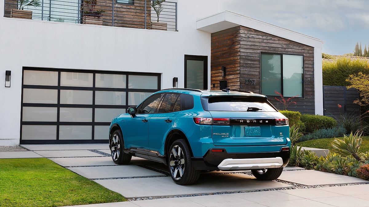 2024 Honda Prologue Elite electric SUV parked in the driveway of a modern home