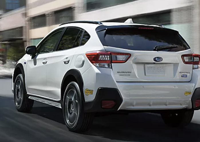 2023 Subaru Crosstrek Hybrid driving on the street