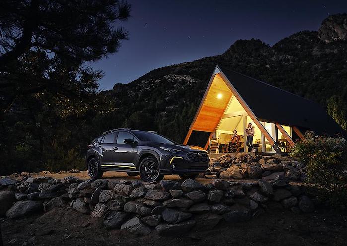 2024 Subaru Crosstrek near a mountain cabin