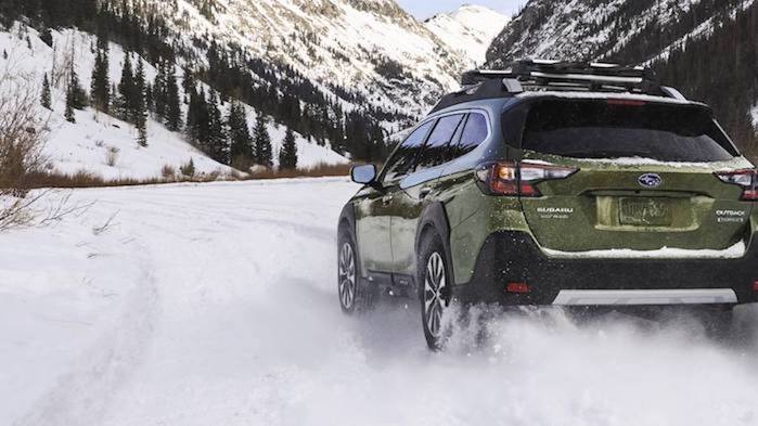 2024 Subaru Outback driving in the snow