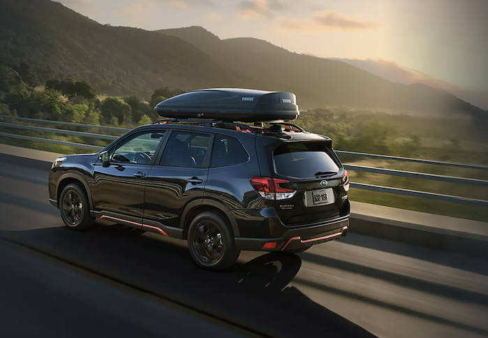 2024 Subaru Forester driving on a scenic highway