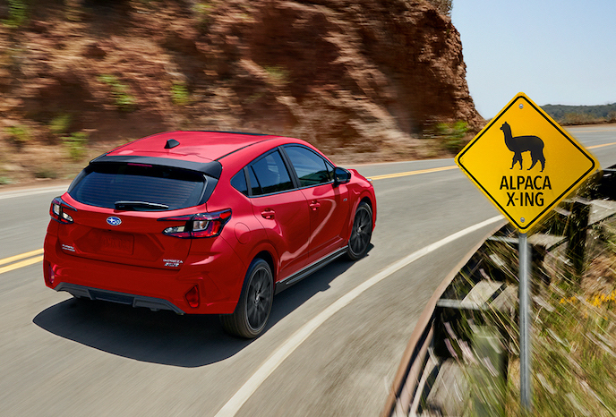 2024 Subaru Impreza driving on a curvy highway