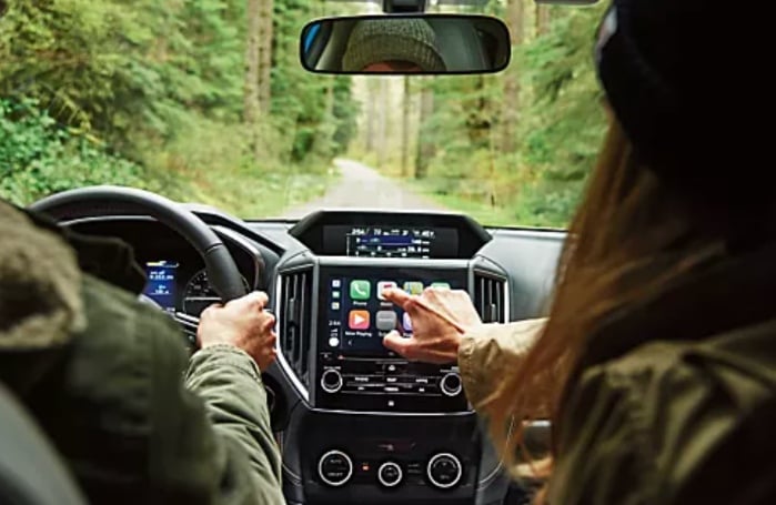 Subaru customer making adjustments on the touchscreen