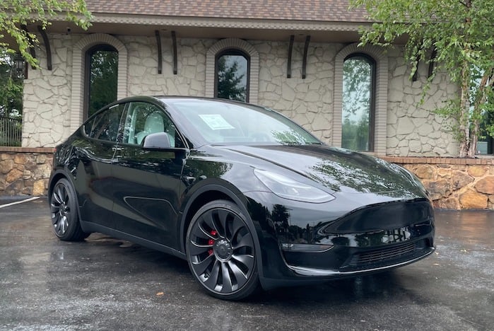 2024 Tesla Model Y in front of a house