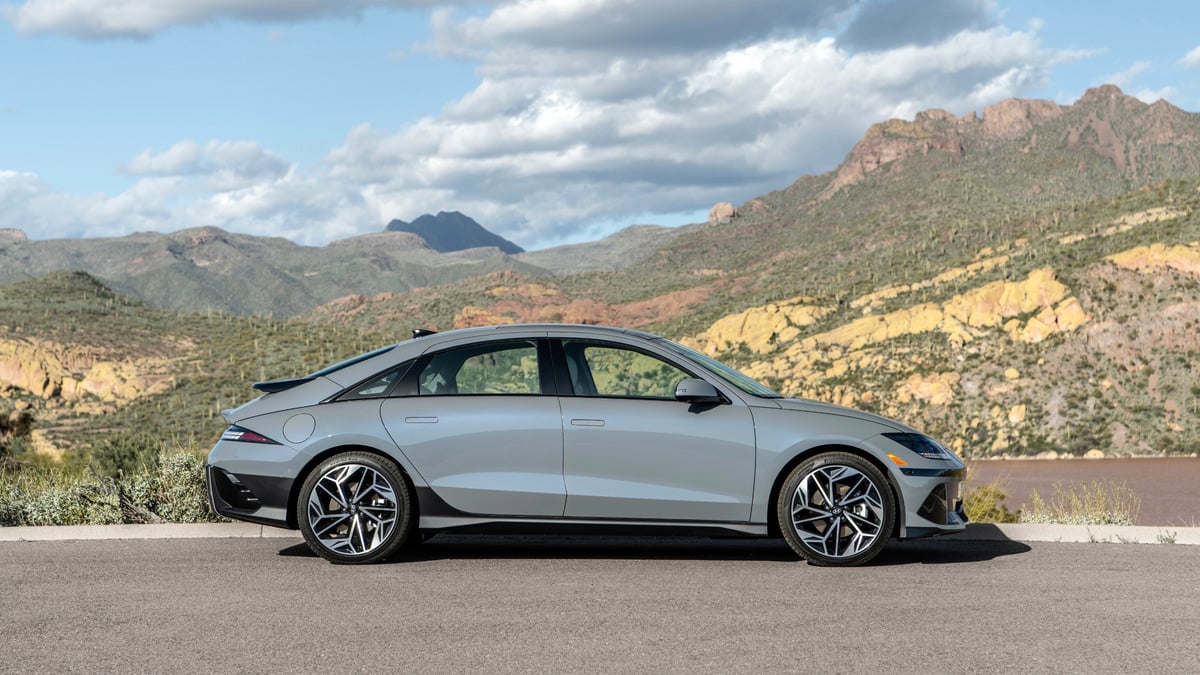 Gray 2024 Hyundai Ioniq 6 Limited shown in side profile with desert mountains in the background.