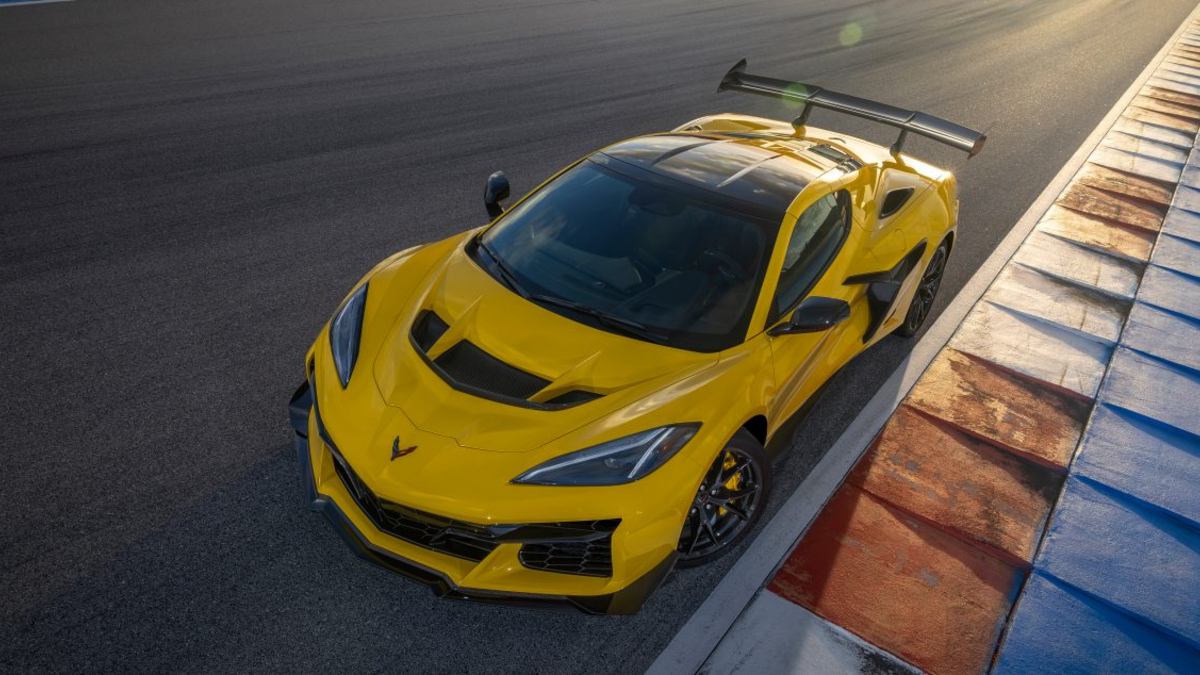 2025 Chevrolet Corvette Z06 in yellow photographed from above on a racetrack, highlighting the hood vents and aerodynamic design.