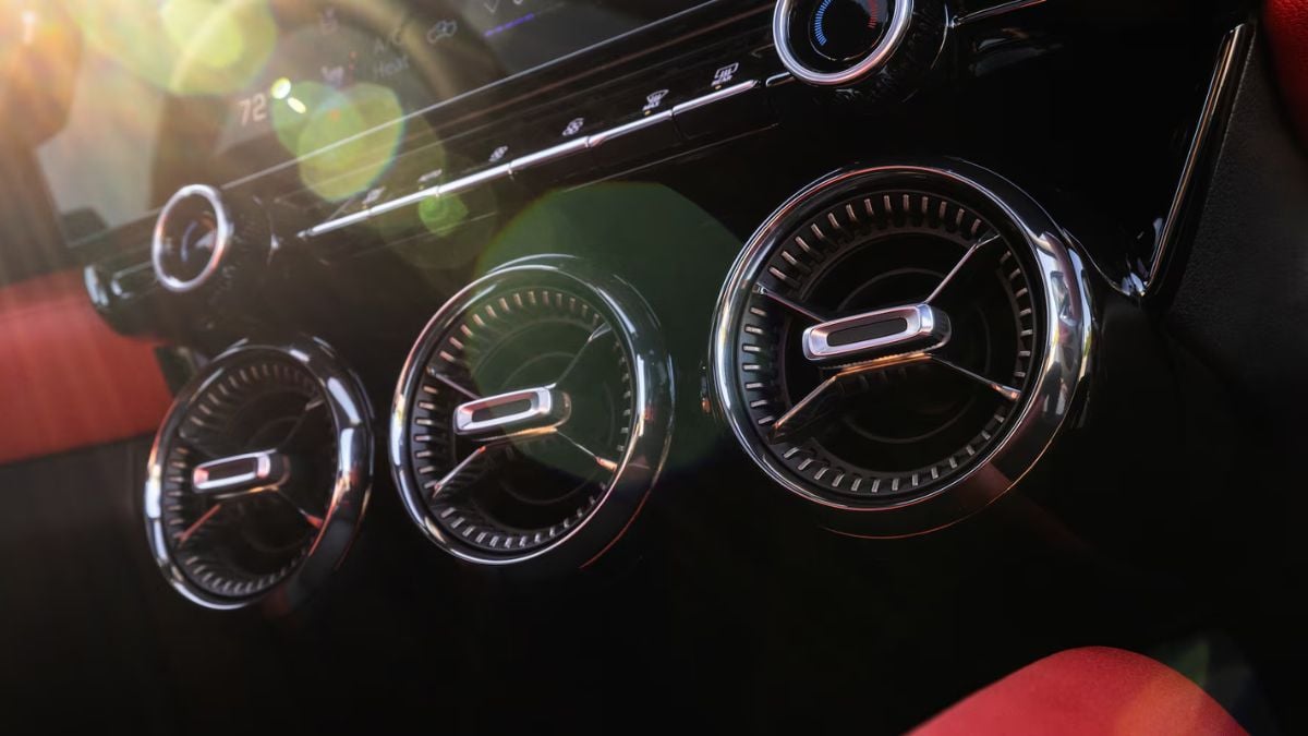 Close-up detail shot of a 2025 Chevrolet Blazer EV's instrument cluster gauges showing chrome-rimmed circular dials with illuminated markings against a black background.