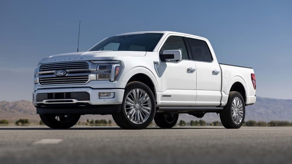 White 2025 Ford F-150 Limited pickup truck shown from a front three-quarter view, featuring chrome accents and premium wheels against a desert mountain backdrop.