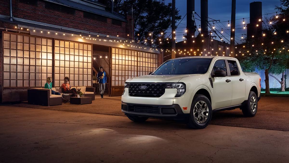 2024 Ford Maverick Tremor in metallic green, shown at three-quarter front angle climbing rocky mountain terrain, featuring off-road wheels and rugged styling.