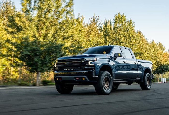 2025 GMC Sierra with the 5.3L engine driving on the road