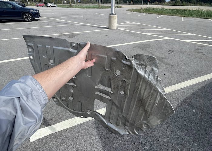 Cole holding his 2025 Honda CR-V damaged engine shield