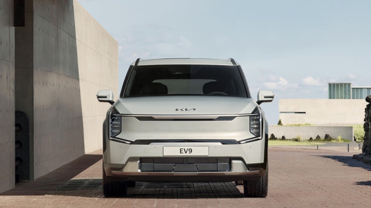 2025 Kia EV9 electric SUV front view in silver, highlighting bold grille-less design, vertical LED headlights, and modern boxy styling.