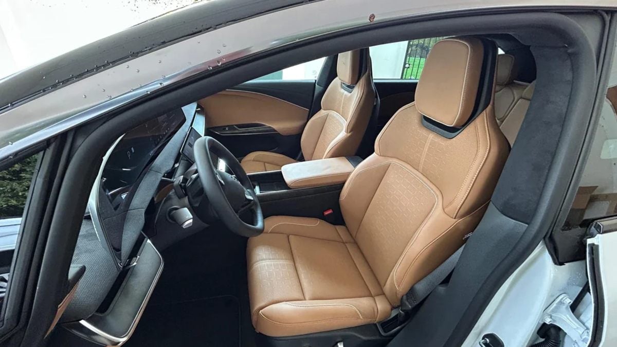 Interior view of Lucid Gravity showing premium tan leather seats with embossed pattern, black dashboard, and minimalist cockpit design.