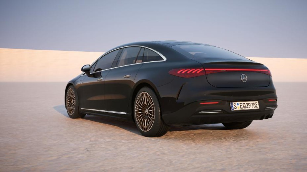2025 Mercedes EQS in black, rear three-quarter view showcasing distinctive taillights and intricate wheel design.