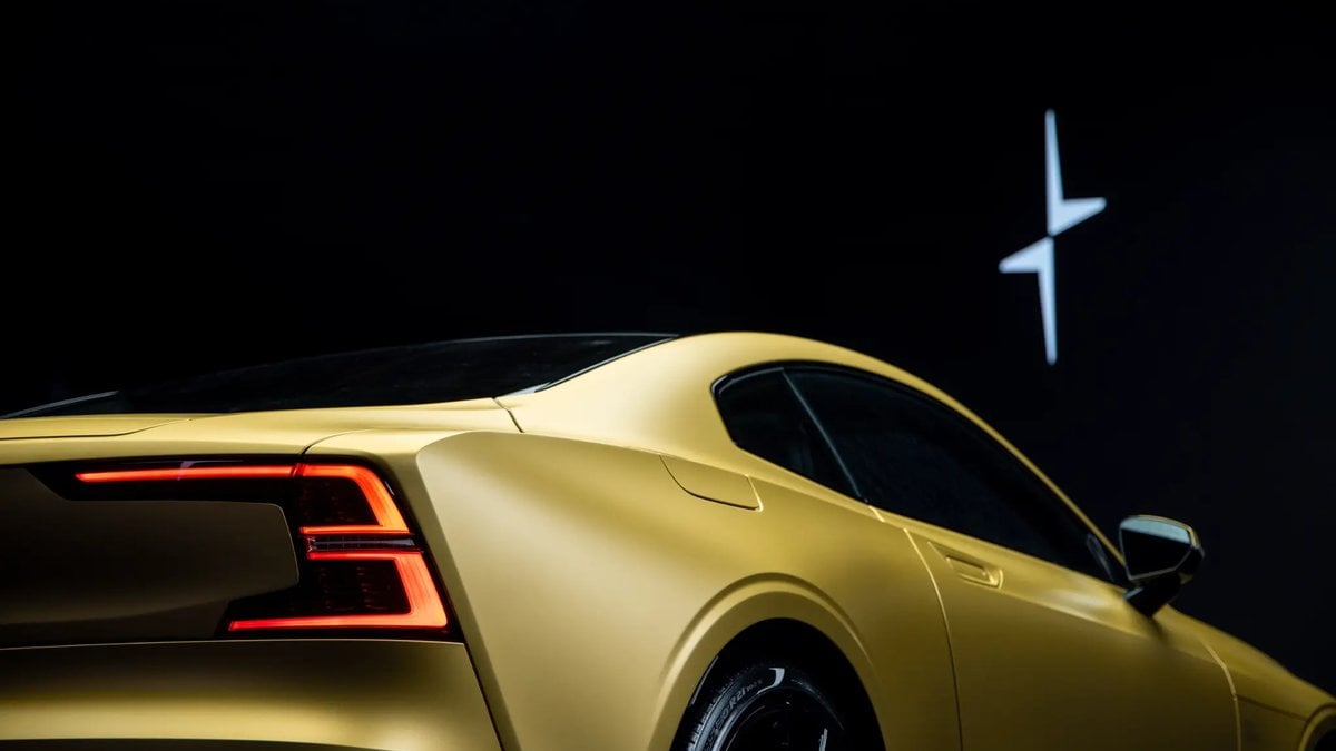A sleek matte gold Polestar car with a dynamic rear design, illuminated brake lights, set against a dark backdrop and brand logo.