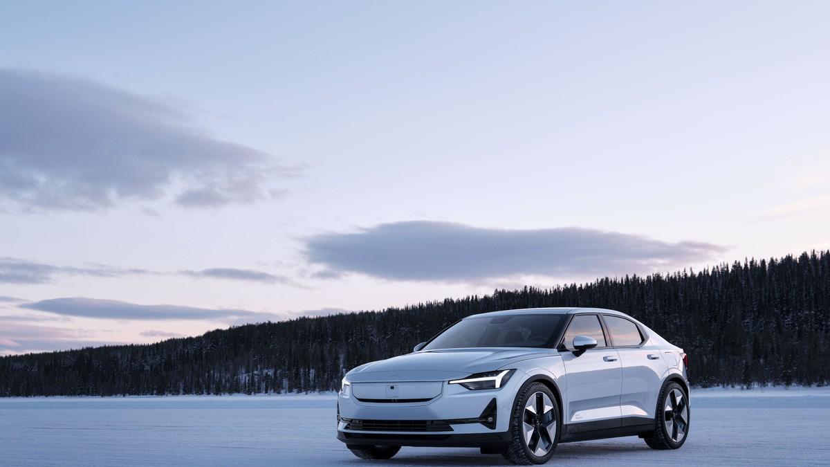 Image of a 2025 Polestar 2 sedan in a silver color, photographed from a low angle showing the front three-quarter view of the vehicle. The image clearly displays the car's exterior design details, including the grille, headlights, and wheel arches.