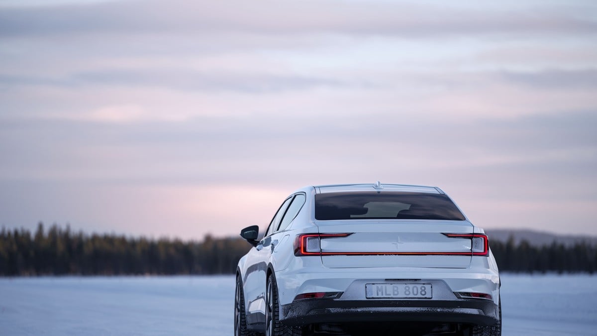 Image of a 2025 Polestar 2 electric sedan in a silver color, photographed from the rear 3/4 angle showing the vehicle's distinctive rear design, taillights, and overall profile.