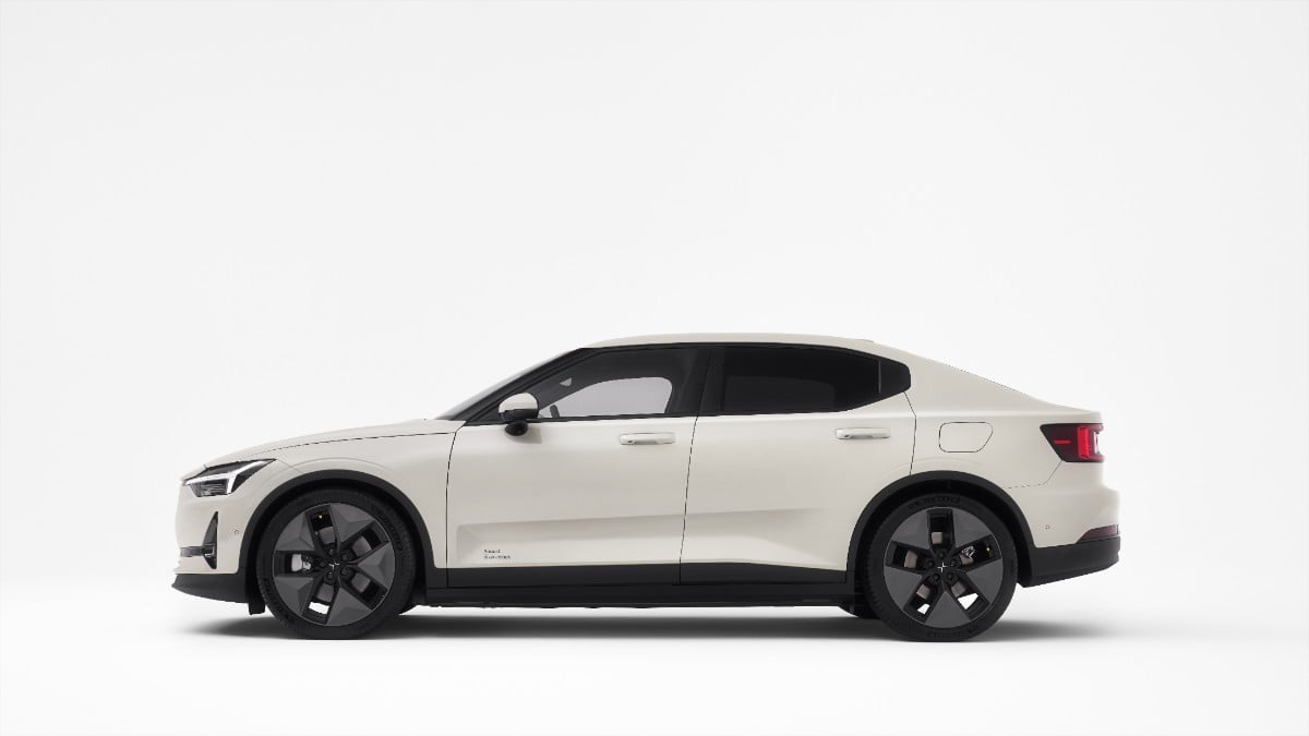 2025 Polestar 2 in white, side view, showcasing black wheels and distinctive body lines against a plain background.