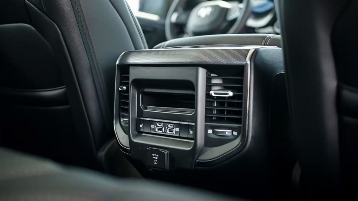 Close-up interior detail shot showing the rear seat climate control vents and interface panel of a 2025 Ram 1500, featuring black leather trim and metallic accents.