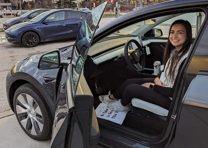 Andres Acosta's wife sitting in a new Tesla Model Y