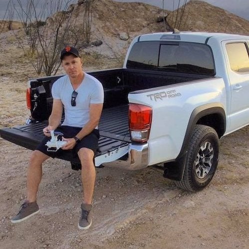 Matt Bryan sitting the Toyota Tacoma tailgate 